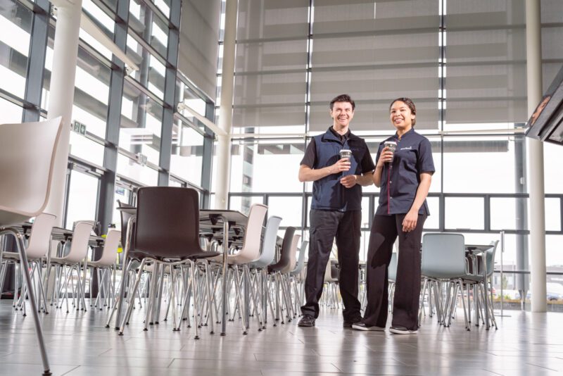 Facilities Management Photography for Sodexo at Scottish Fire and Rescue HQ, Glasgow 8 Two Sodexo colleagues holding coffee cups and smiling in an empty canteen