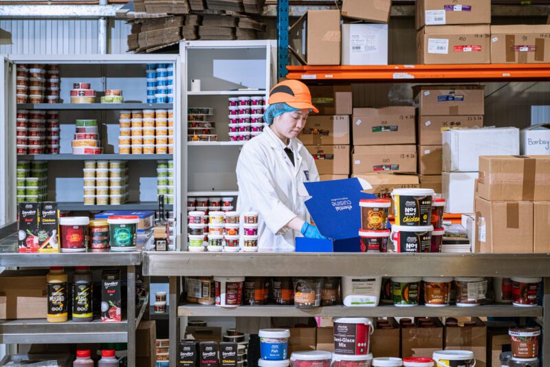 Essential Cuisine - behind the scenes 3 Production staff packing Essential Cuisine seasoning tubs, including Korma, Rogan Josh and Bombay ranges