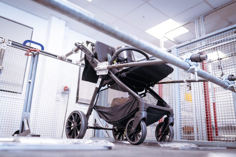 Photographing the invisible: inside SGS's new testing laboratory 6 Pushchair clamped into a mechanical durability test rig inside a wire mesh safety cage