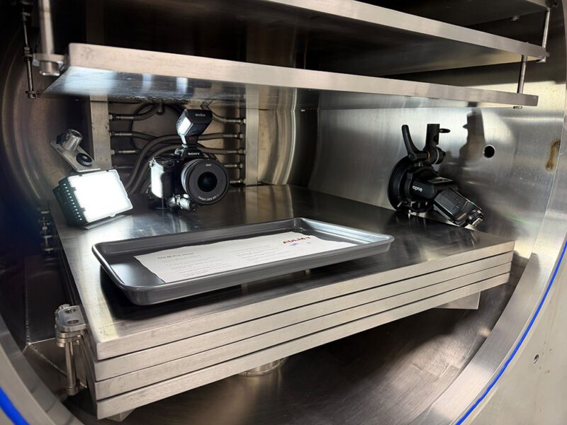 Growing a Commercial & Industrial Photography Business 9 Camera, flash and LED light rigged inside a freeze-dryer chamber alongside an empty sample tray, set up for the Biofortuna hero shot
