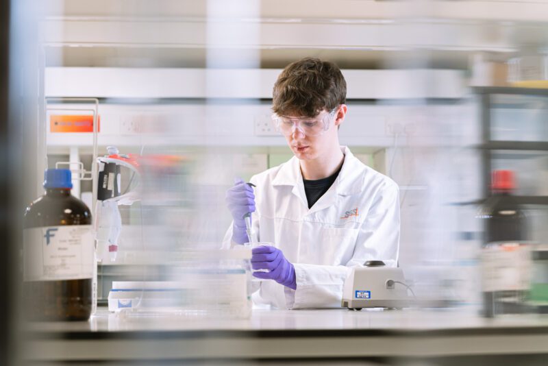 Photographing the People Behind SGS Vitrology's New Glasgow Lab 14 Analyst carefully pipetting a solution into a beaker on a magnetic stirrer at SGS Vitrology's Glasgow laboratory.