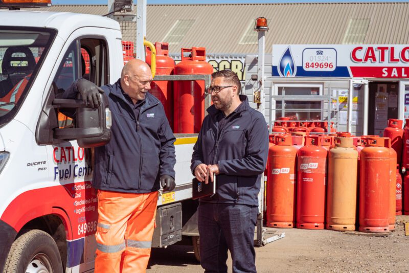 Growing a Commercial & Industrial Photography Business 5 Two FloGas Proud Partner staff talking beside a Catlow Fuel Centre delivery van, with gas cylinders stacked behind
